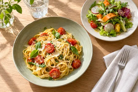 An illustrative pasta and salad lunch in a bright bistro